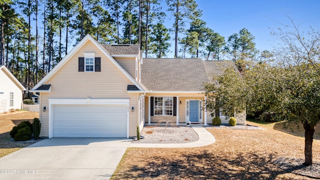 traditional home featuring concrete driveway, a garage, and roof with shingles