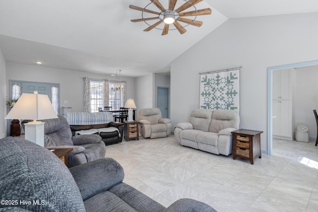 living room featuring ceiling fan with notable chandelier and high vaulted ceiling