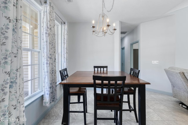 dining room featuring visible vents, baseboards, and a chandelier