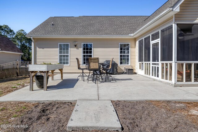 view of patio / terrace with outdoor dining area, fence, grilling area, and a sunroom