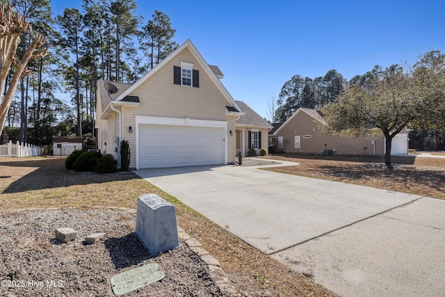 view of side of home with driveway and fence