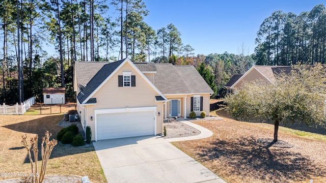 traditional home with central air condition unit, concrete driveway, roof with shingles, and fence