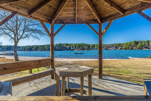 view of patio with a gazebo and a water view