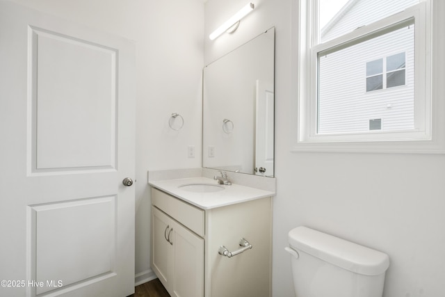 half bathroom featuring toilet and vanity