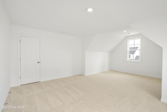 additional living space featuring baseboards, carpet floors, and lofted ceiling