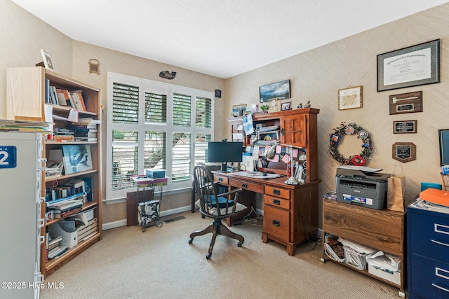 home office featuring visible vents, a textured ceiling, baseboards, and carpet floors