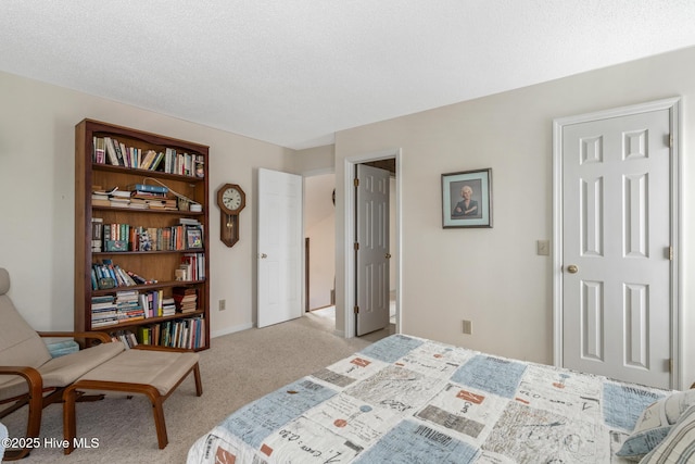 bedroom featuring baseboards, carpet floors, and a textured ceiling