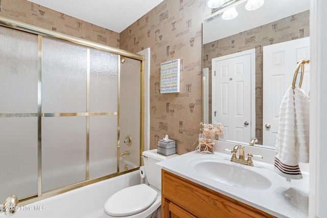 full bath featuring combined bath / shower with glass door, toilet, wallpapered walls, and vanity