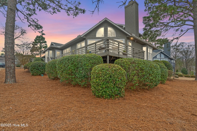 rear view of property with a chimney