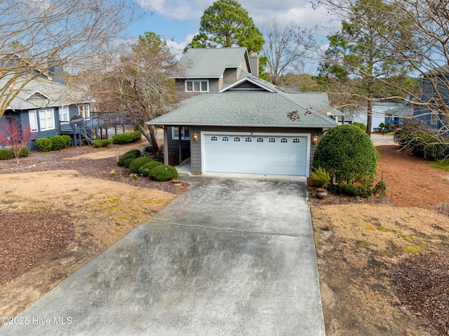 view of front of house featuring a garage, a chimney, driveway, and a shingled roof