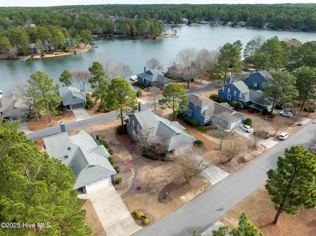 bird's eye view with a forest view and a water view