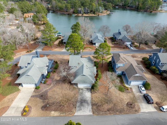 drone / aerial view featuring a water view and a residential view