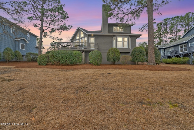 exterior space featuring a chimney and a yard