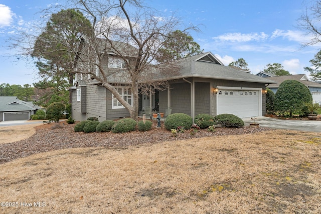 view of front of property featuring a garage, concrete driveway, and a shingled roof