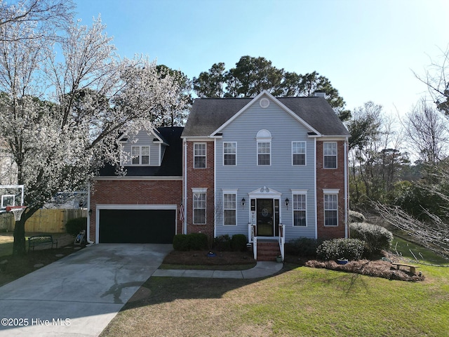 colonial house with a front lawn, fence, concrete driveway, a garage, and brick siding