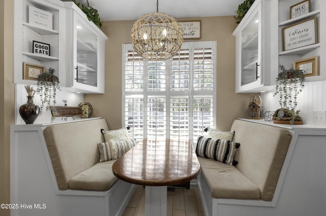 dining area featuring a chandelier and wood finished floors