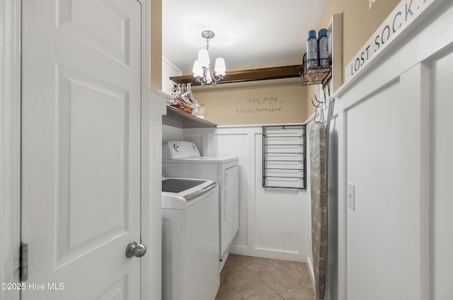 laundry area with washer and clothes dryer, laundry area, and light tile patterned floors