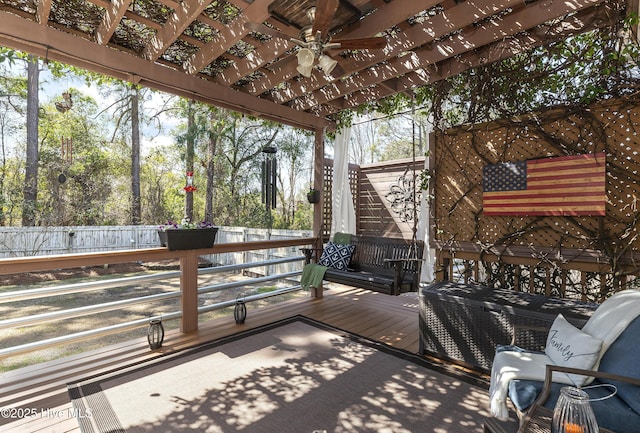 deck with a fenced backyard and a pergola