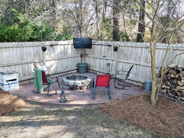 view of yard with a patio area, an outdoor fire pit, and fence