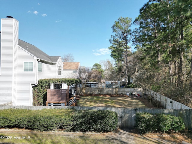 view of yard featuring a wooden deck and fence