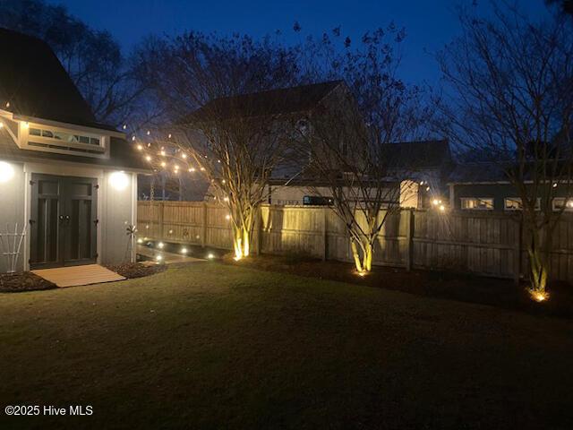 yard at night with fence