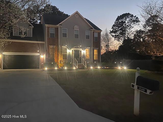 colonial inspired home with concrete driveway