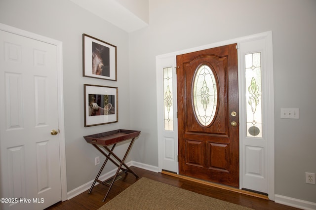 entrance foyer with baseboards and dark wood-type flooring