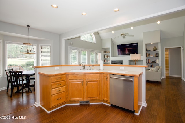 kitchen with open floor plan, dishwasher, light countertops, and a sink