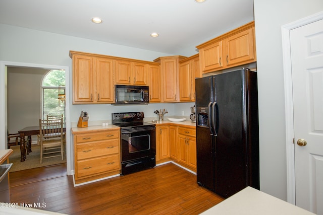 kitchen with dark wood finished floors, recessed lighting, black appliances, and light countertops