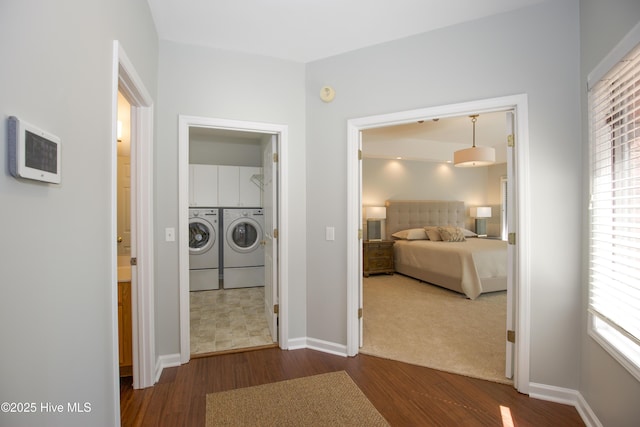 bedroom featuring baseboards, independent washer and dryer, and wood finished floors