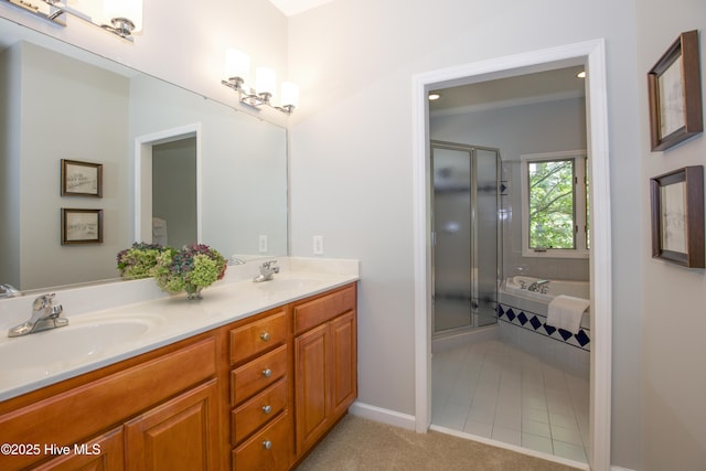 bathroom with a sink, a garden tub, double vanity, and a shower stall