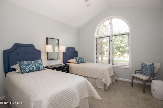 carpeted bedroom featuring multiple windows, baseboards, and lofted ceiling