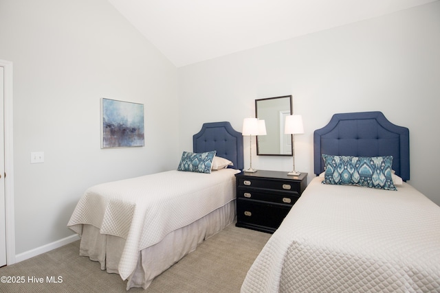 carpeted bedroom with baseboards and lofted ceiling