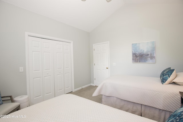 bedroom featuring a closet, lofted ceiling, carpet, and baseboards