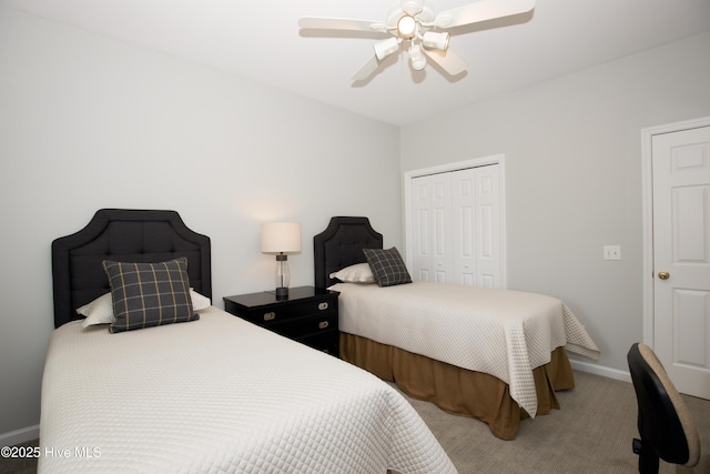 carpeted bedroom featuring a closet, baseboards, and ceiling fan