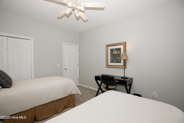 carpeted bedroom featuring a closet, baseboards, and ceiling fan