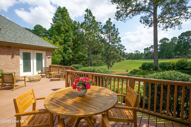 deck with outdoor dining space and french doors