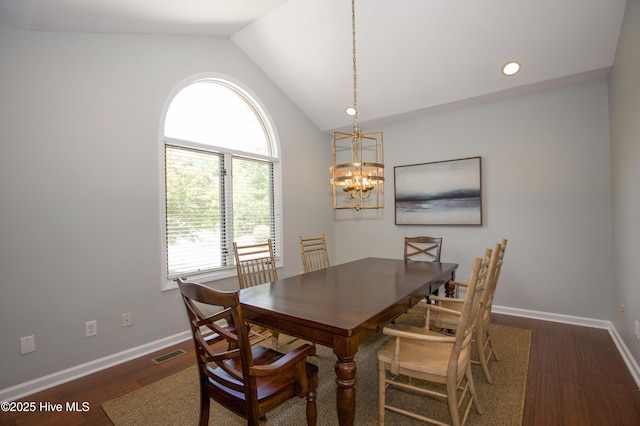 dining space with an inviting chandelier, wood finished floors, baseboards, and vaulted ceiling