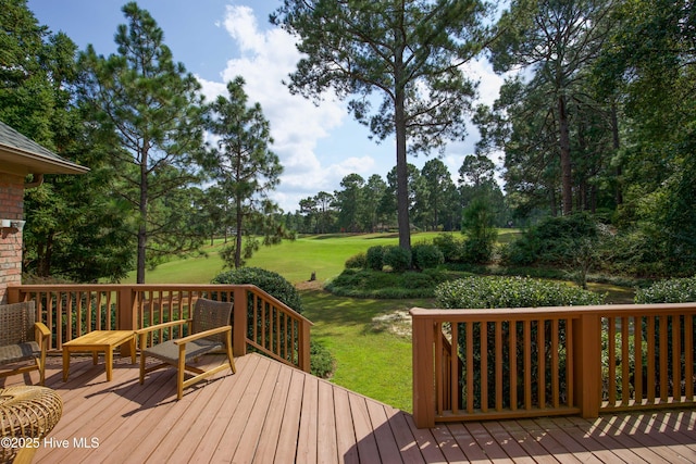 wooden deck featuring a yard