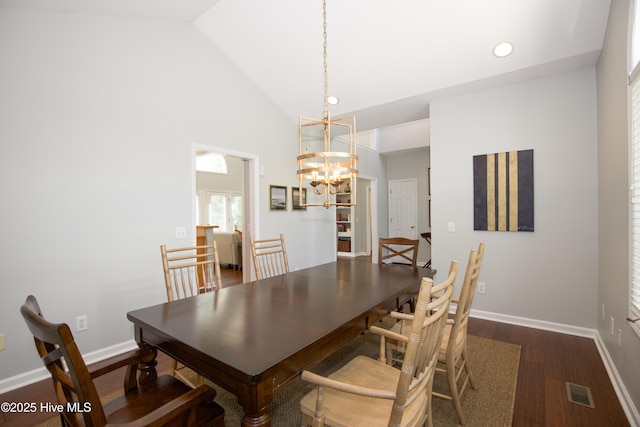 dining area featuring a chandelier, visible vents, baseboards, and dark wood-style flooring