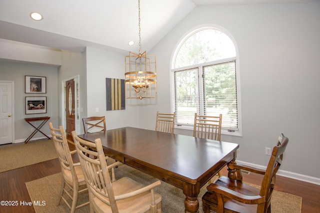 dining room featuring dark wood-style floors, lofted ceiling, baseboards, and a chandelier