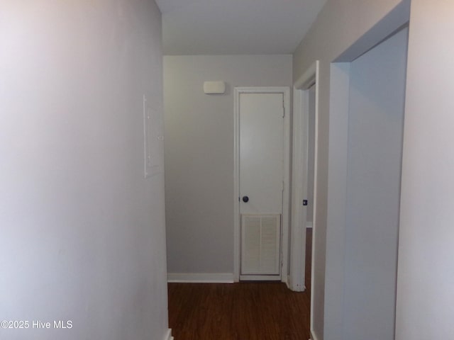 corridor with visible vents, baseboards, and wood finished floors