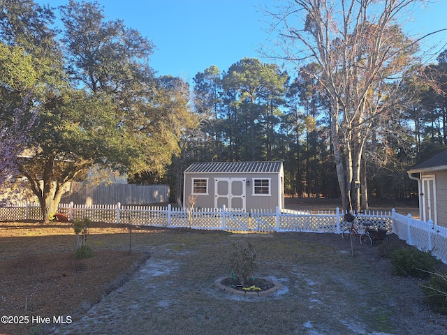 exterior space with an outdoor structure, a storage unit, and fence private yard