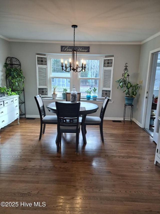 dining area featuring an inviting chandelier, baseboards, dark wood-style flooring, and ornamental molding