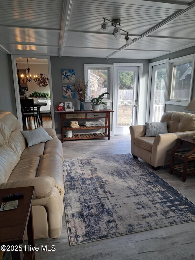 living area with an inviting chandelier and wood finished floors