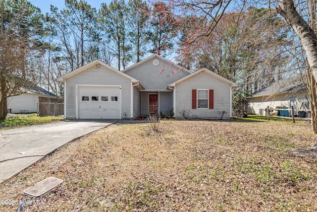 view of front of house featuring a garage, driveway, and fence