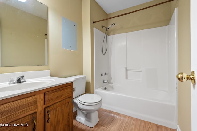 full bathroom featuring bathing tub / shower combination, toilet, wood finished floors, and vanity