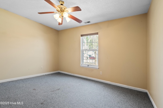 carpeted spare room featuring ceiling fan, baseboards, visible vents, and a textured ceiling