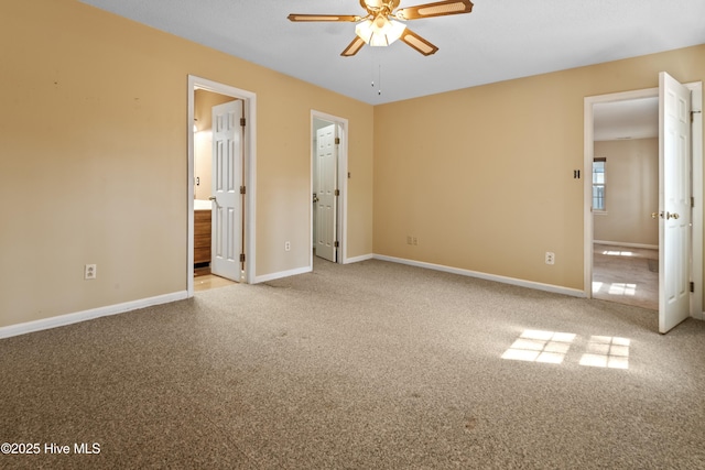 unfurnished bedroom with ensuite bath, carpet, and baseboards