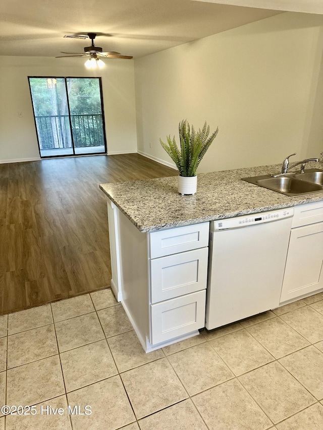 kitchen with a ceiling fan, light tile patterned flooring, a sink, white cabinets, and dishwasher